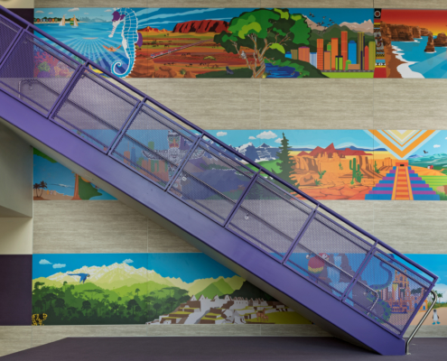 Pomeroy Elementary School wall panels near staircase featuring bright vivid cultural graphics