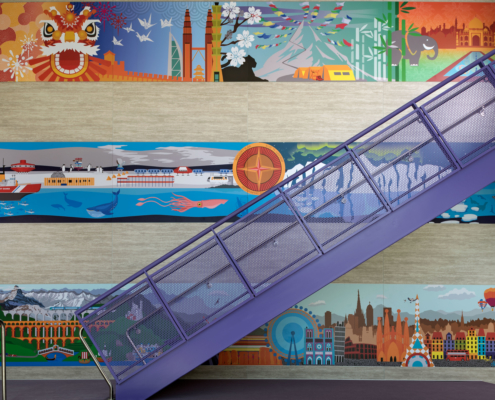 Pomeroy Elementary School wall mural beside staircase featuring bright vivid cultural graphics