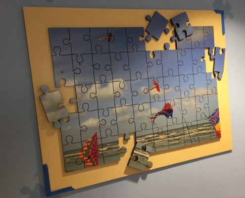 Texas Children's Hospital puzzle like wall panel featuring kites and puzzle pieces attached seperately of the main panel